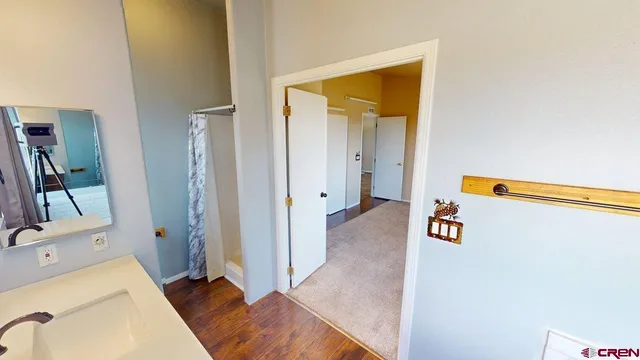 a area with closet and a mirror