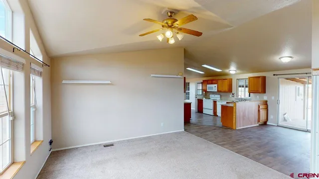 wooden floor in an empty room with a kitchen