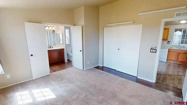 a view of empty room with wooden floor and cabinet