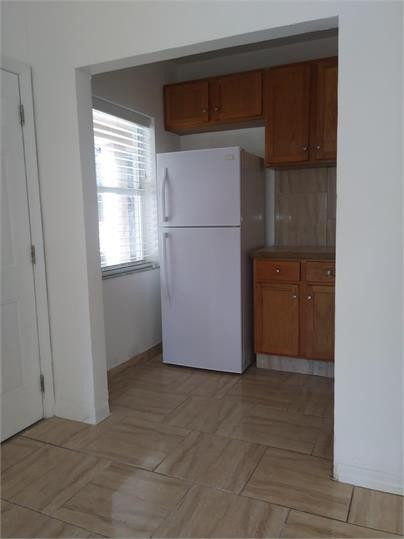 8910 Collins Avenue, Unit 1 Surfside, FL 33154 - Photo 8 of 16 a view of kitchen with a refrigerator