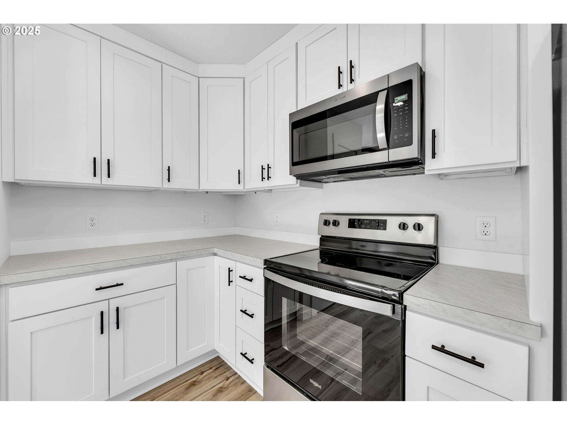 805 West Front Street Winlock, WA 98596 - Photo 14 of 31 a kitchen with white cabinets and stainless steel appliances