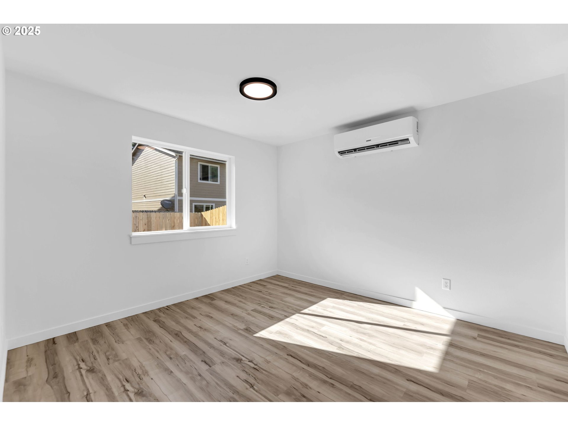 805 West Front Street Winlock, WA 98596 - Photo 7 of 31 an empty room with wooden floor and windows