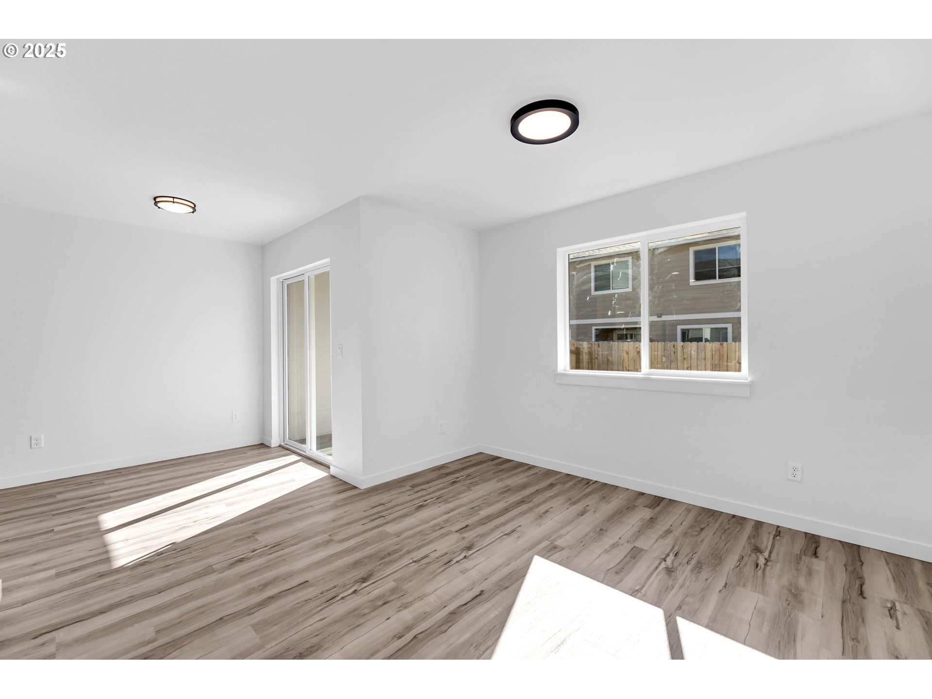805 West Front Street Winlock, WA 98596 - Photo 10 of 31 a view of an empty room with wooden floor and a window