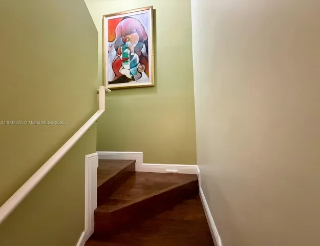 a view of hallway with paintings on the wall