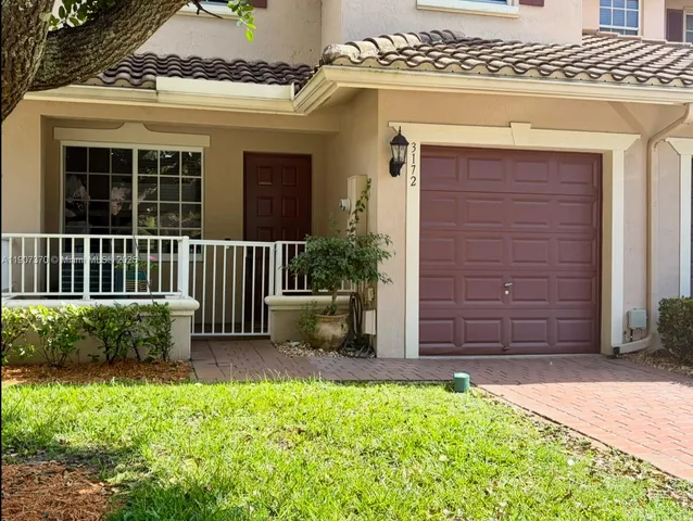 front view of a house with a garden