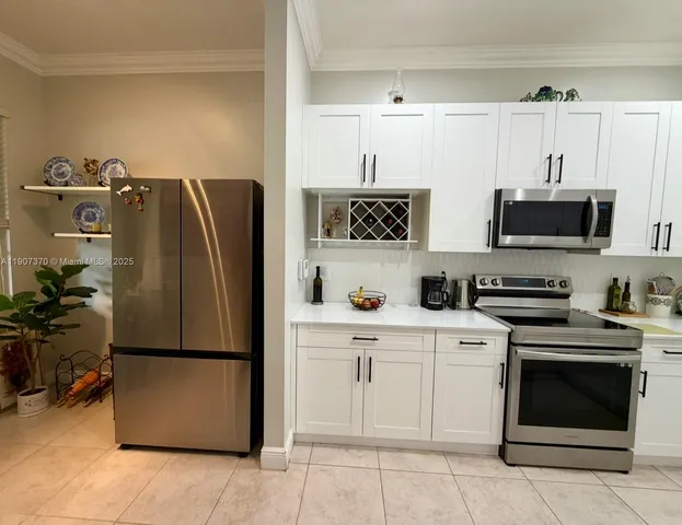 a kitchen with stainless steel appliances a refrigerator stove and microwave