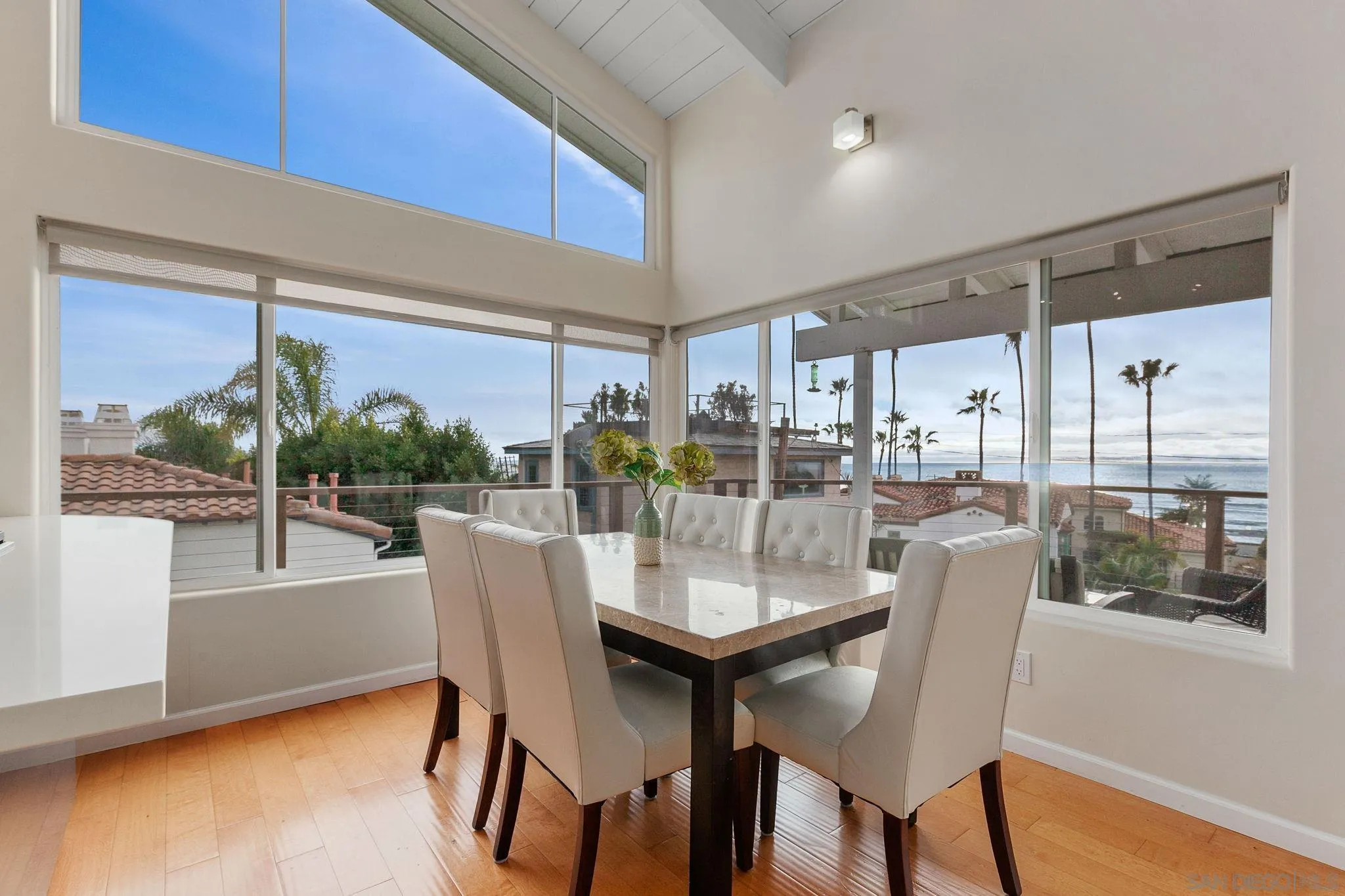 5620 La Jolla Boulevard La Jolla, CA 92037 - Photo 11 of 50 a dining room with furniture a rug and a floor to ceiling window