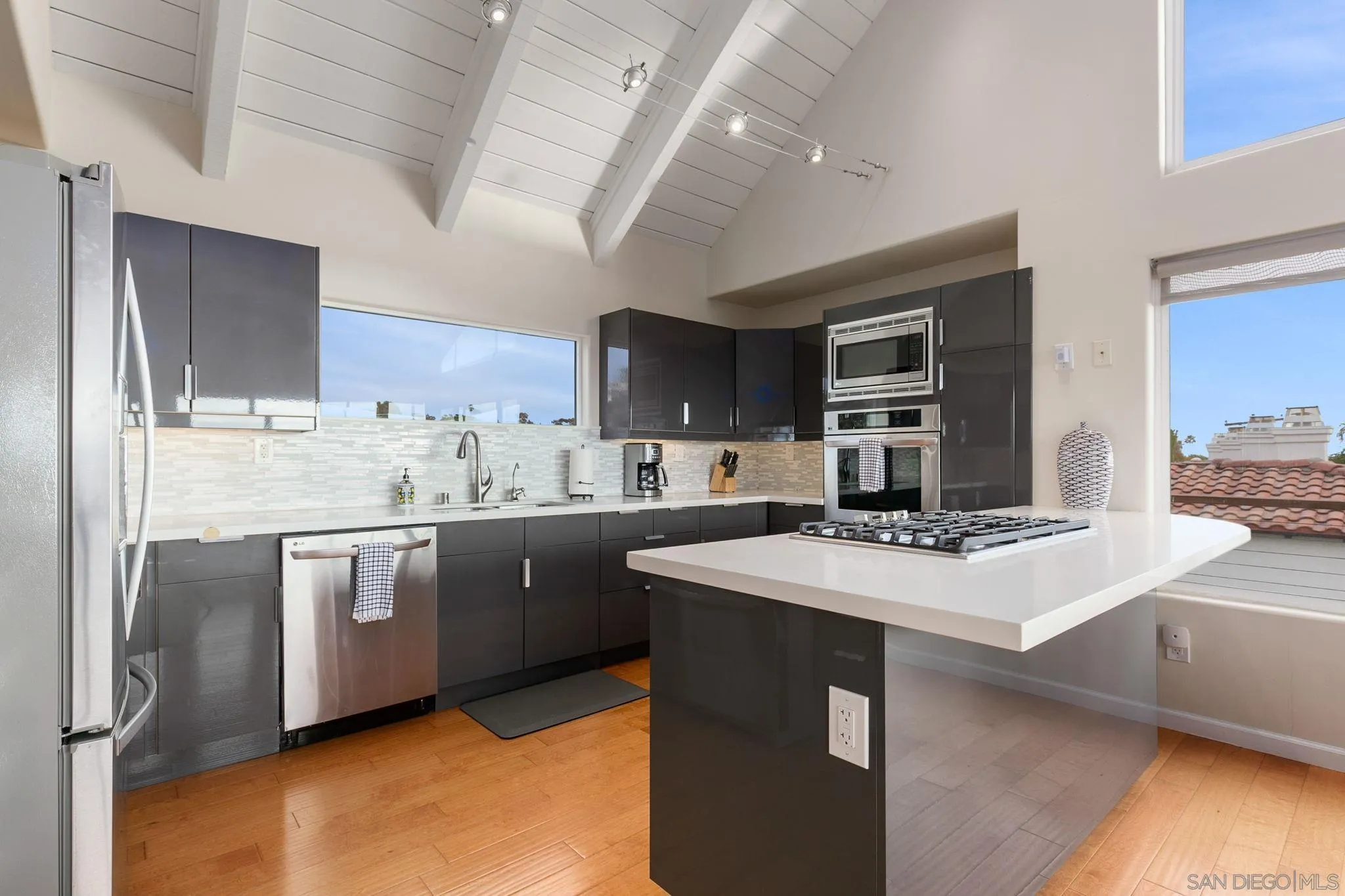 5620 La Jolla Boulevard La Jolla, CA 92037 - Photo 18 of 50 a kitchen with stainless steel appliances sink stove refrigerator and cabinets