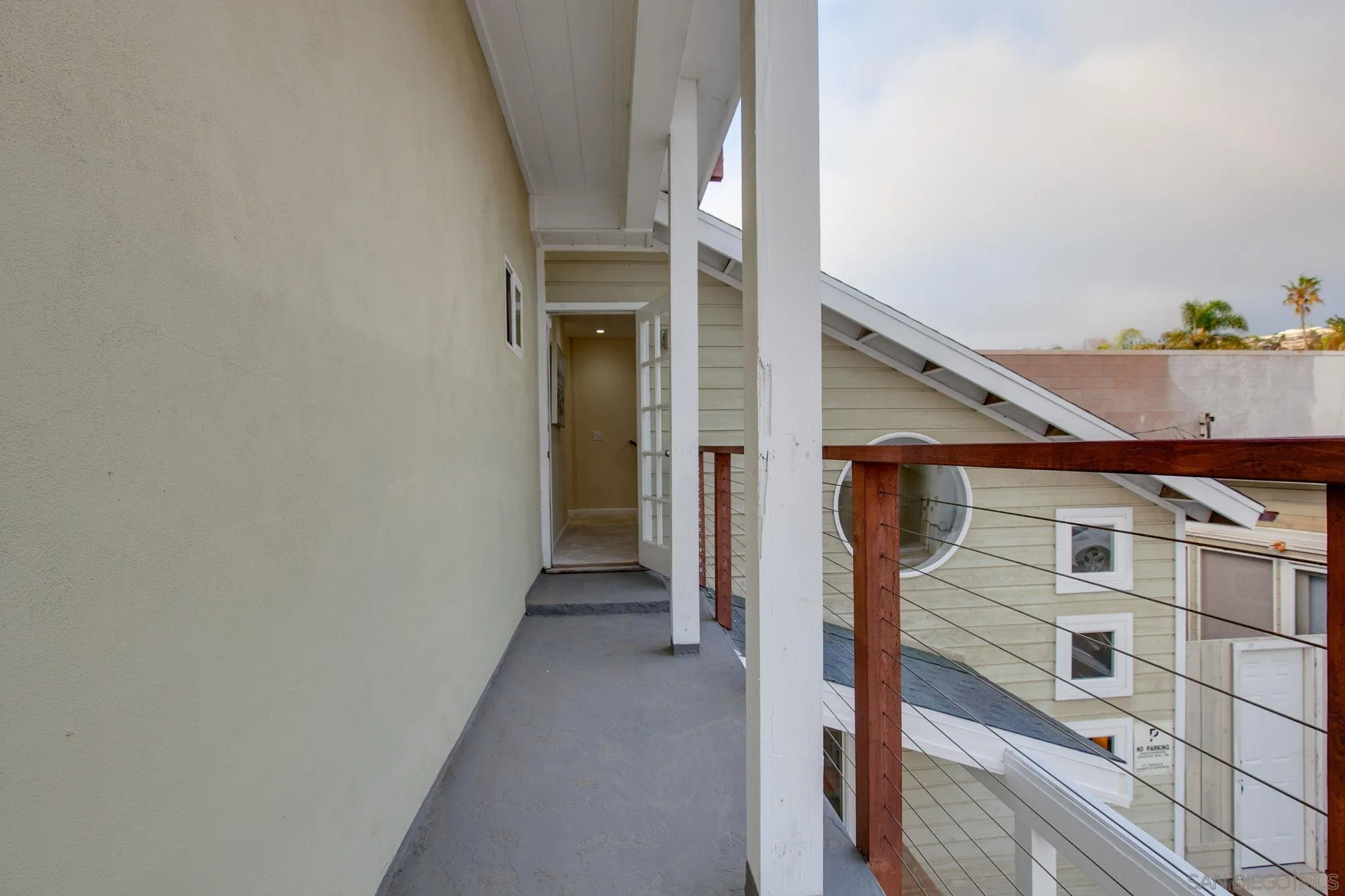 5620 La Jolla Boulevard La Jolla, CA 92037 - Photo 27 of 50 a view of a hallway with wooden shelves and stairs