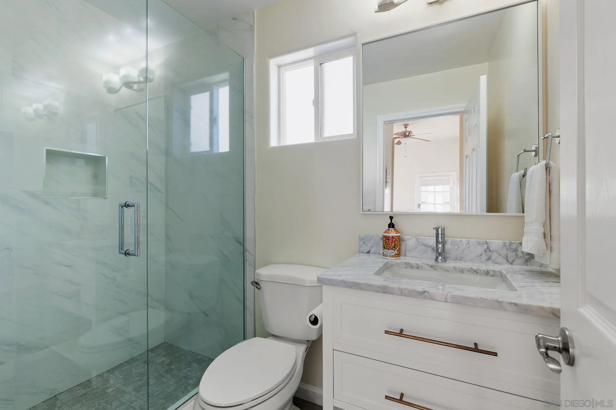 5620 La Jolla Boulevard La Jolla, CA 92037 - Photo 34 of 50 a bathroom with a granite countertop toilet sink shower and mirror