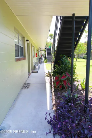 a view of a porch with couches and potted plants