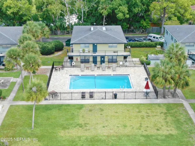 an aerial view of a house with swimming pool garden and patio