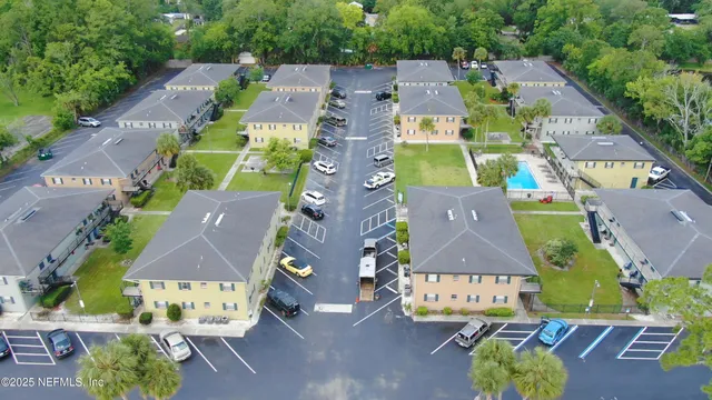 an aerial view of residential houses with outdoor space and street view