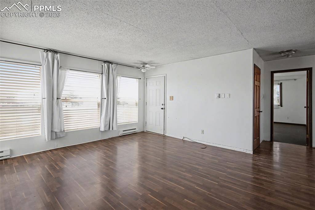 12380 Old Barn Road Elbert, CO 80106 - Photo 4 of 42 a view of an empty room with wooden floor and a window