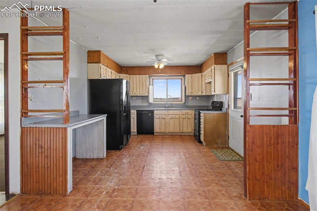 12380 Old Barn Road Elbert, CO 80106 - Photo 7 of 42 a kitchen with a refrigerator a microwave oven cabinets and a counter top space
