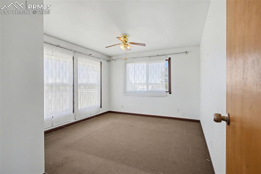 12380 Old Barn Road Elbert, CO 80106 - Photo 10 of 42 an empty room with windows and fan