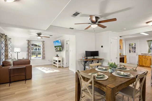 a kitchen with granite countertop stainless steel appliances a refrigerator cabinets and wooden floor