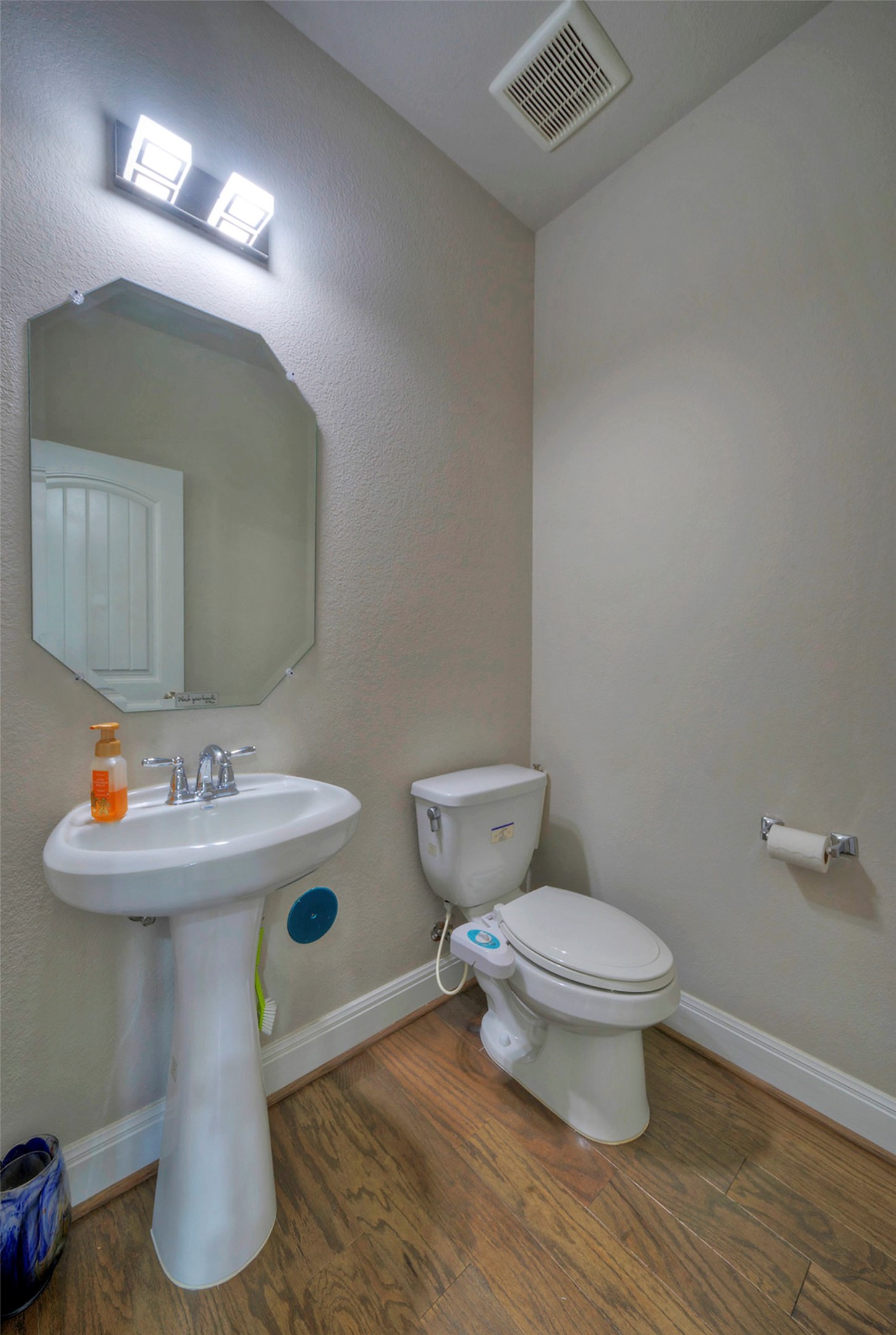 2260 Hat Bender Loop Round Rock, TX 78664 - Photo 13 of 40 Hardwood floors and a pedestal sink elevate this compact 1/2 powder room.