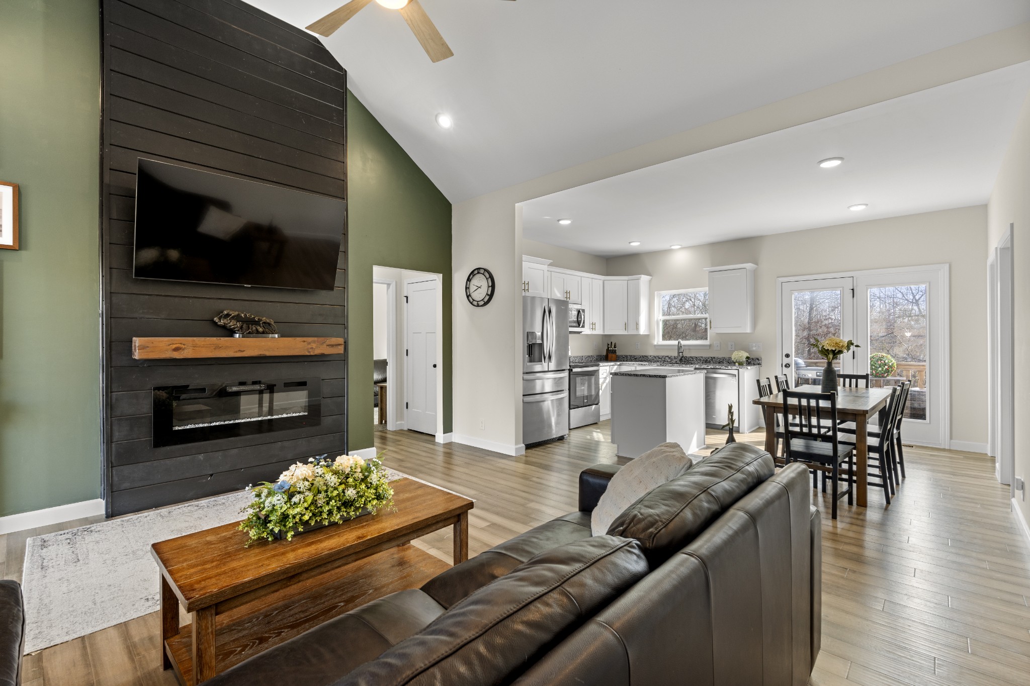 a living room with furniture and kitchen view
