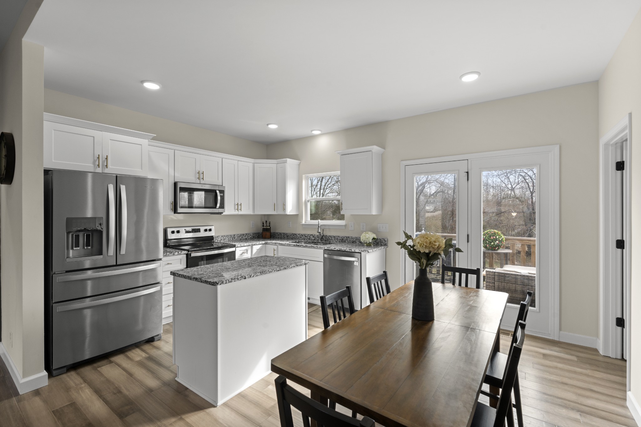 1007 Edgewood Drive Dickson, TN 37055 - Photo 6 of 25 a kitchen with stainless steel appliances granite countertop a stove a refrigerator a kitchen island a table and chairs