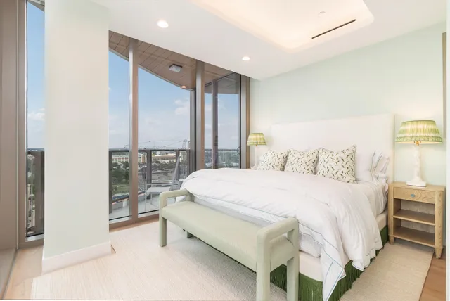 a large bed sitting in a bedroom next to a cabinet