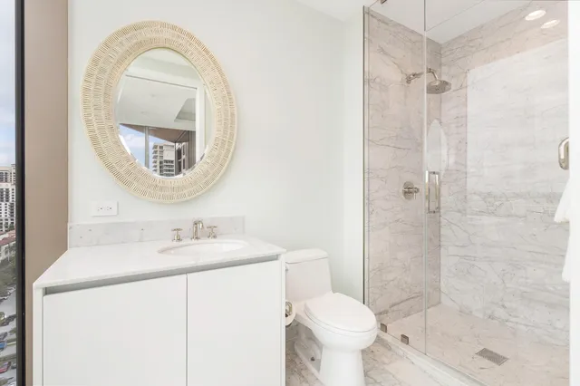 a bathroom with a sink toilet and shower