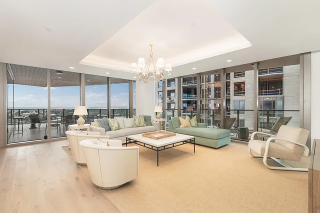 a living room with furniture and a chandelier