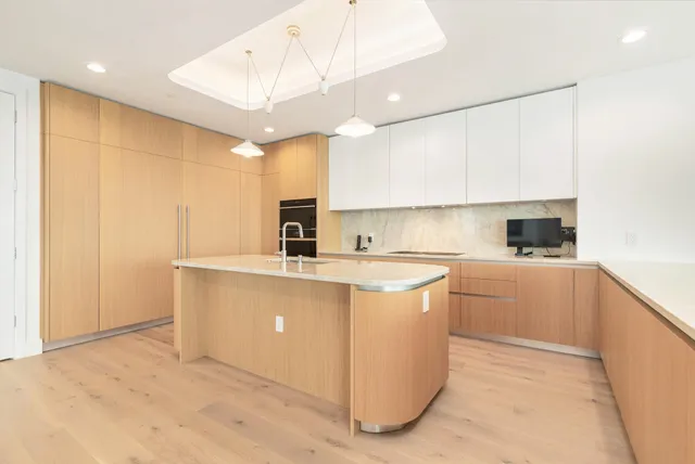 a kitchen with stainless steel appliances granite countertop a sink and a refrigerator