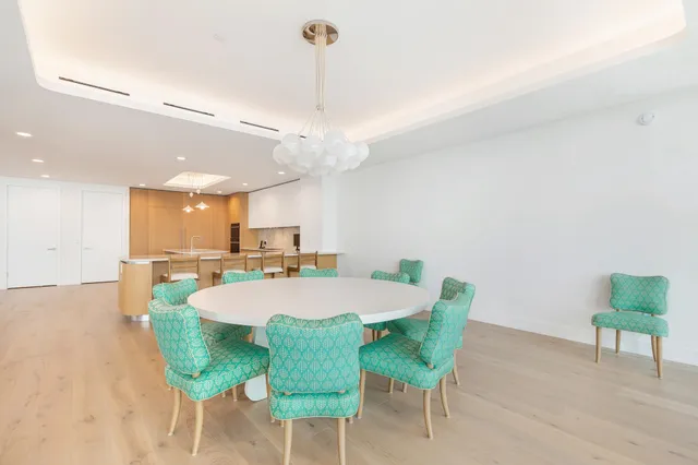 a large kitchen with a table and chairs
