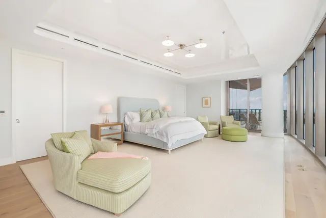 a bedroom with bed and a chandelier