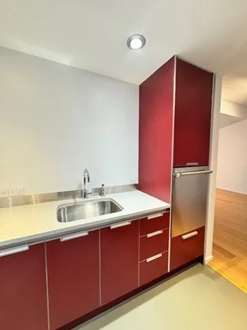 a kitchen with a refrigerator and a sink