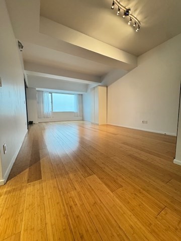 141 Dorchester Avenue, Unit 806 Boston, MA 02127 - Photo 5 of 12 a view of empty room with wooden floor