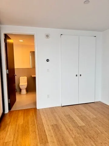 a view of a bedroom with a hardwood and hallway
