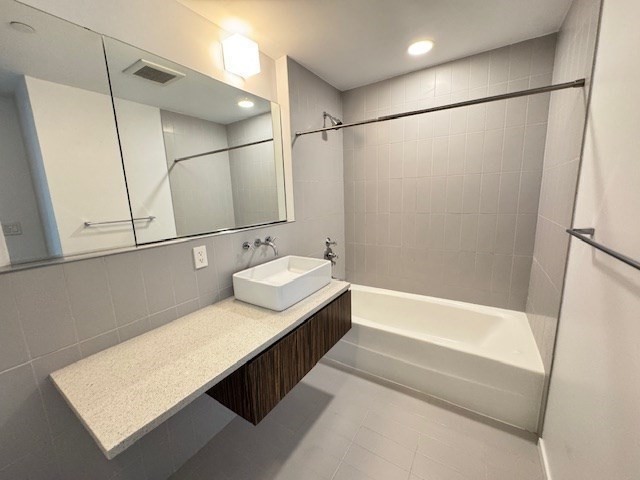 141 Dorchester Avenue, Unit 806 Boston, MA 02127 - Photo 9 of 12 a bathroom with a tub sink and shower