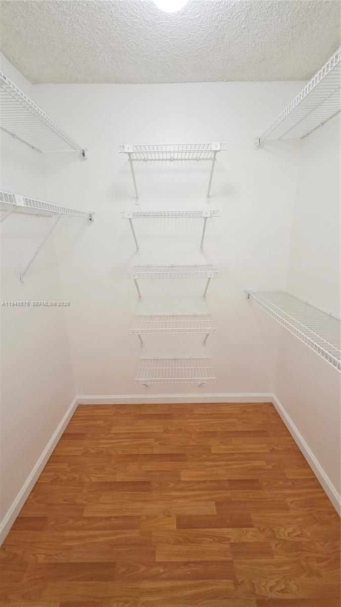 7124 Southwest 114th Place, Unit A Miami, FL 33173 - Photo 13 of 19 a view of a room with empty racks