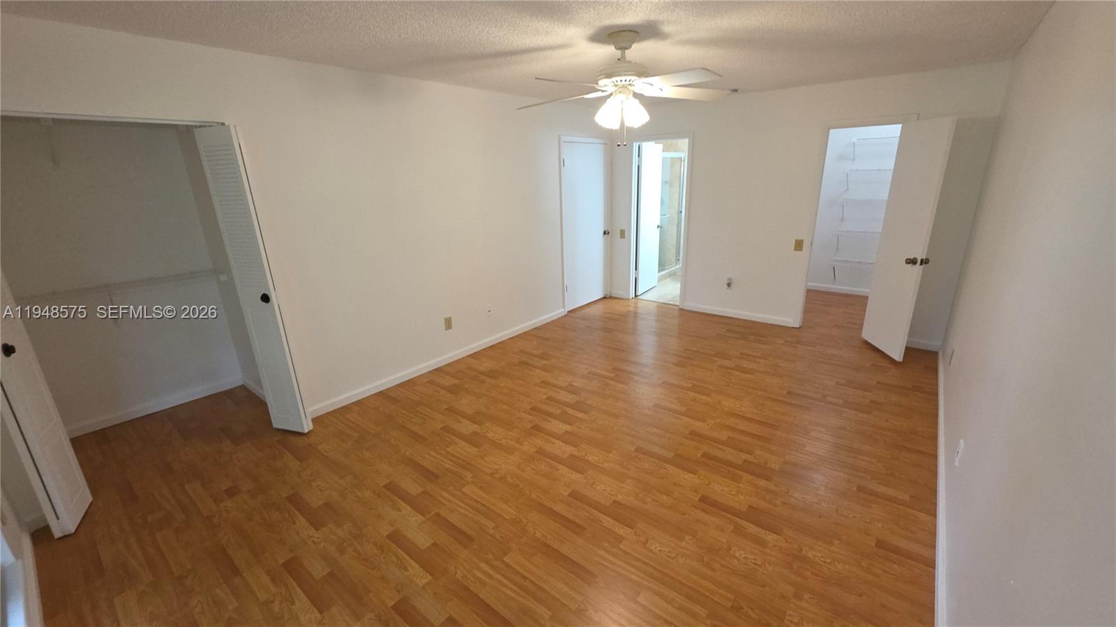 7124 Southwest 114th Place, Unit A Miami, FL 33173 - Photo 14 of 19 wooden floor in an empty room with a window