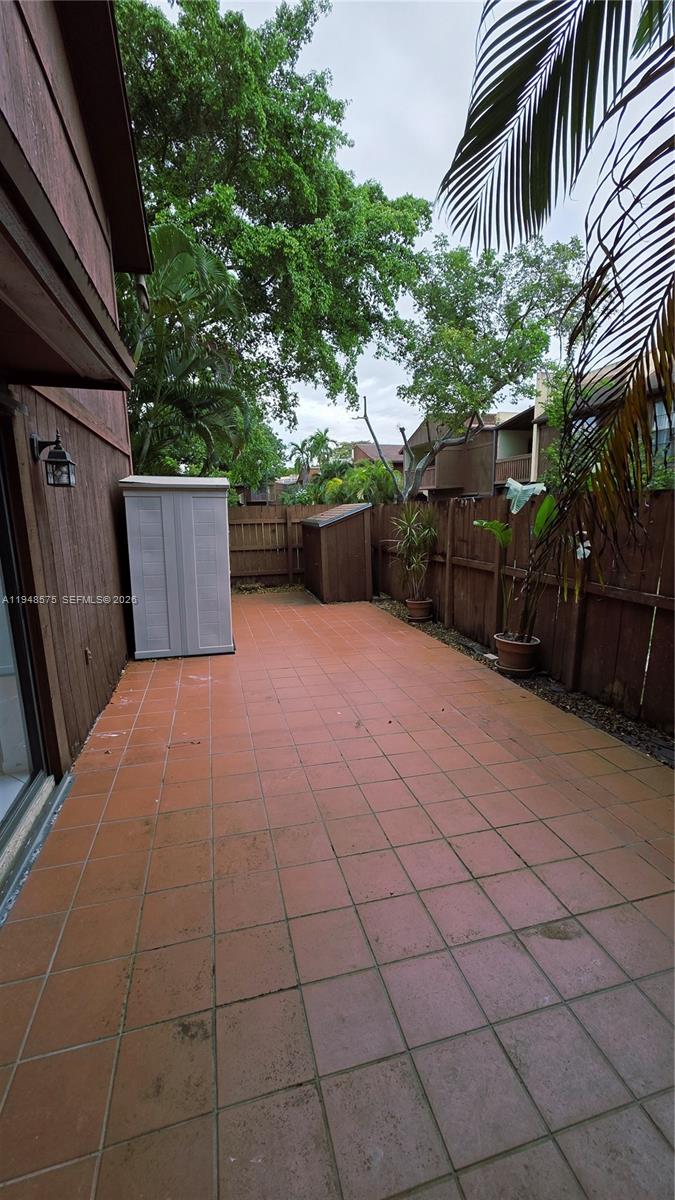 7124 Southwest 114th Place, Unit A Miami, FL 33173 - Photo 16 of 19 a view of backyard and wooden fence