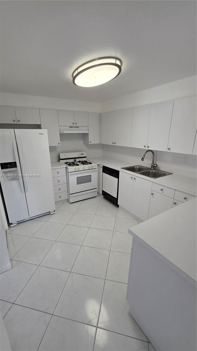 7124 Southwest 114th Place, Unit A Miami, FL 33173 - Photo 2 of 19 a kitchen with granite countertop a sink and a stove top oven