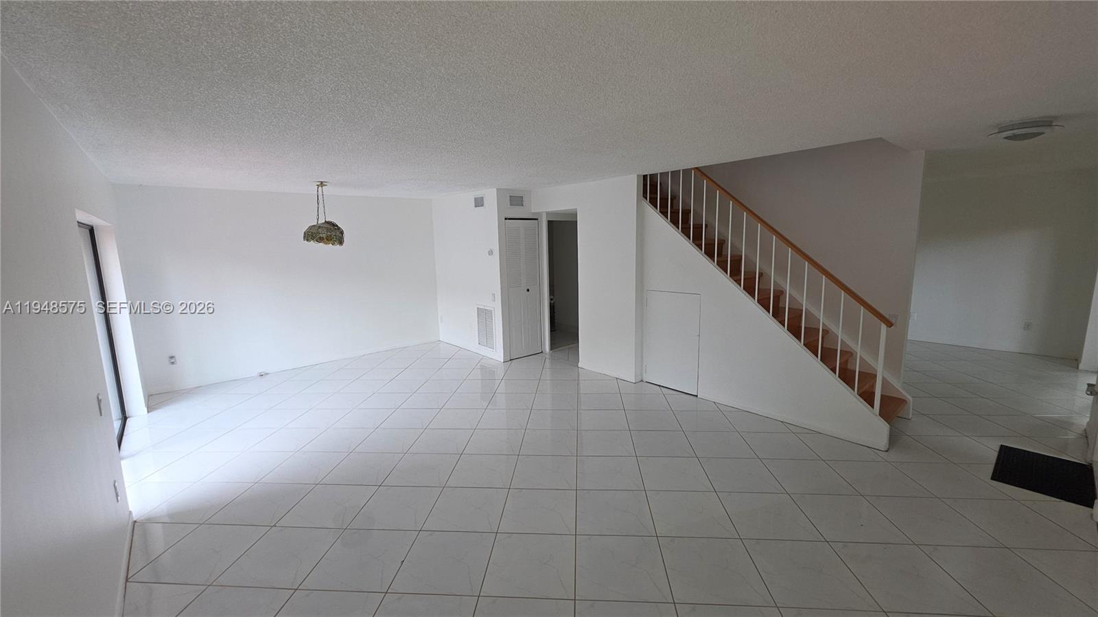 7124 Southwest 114th Place, Unit A Miami, FL 33173 - Photo 3 of 19 a view of a hallway with staircase