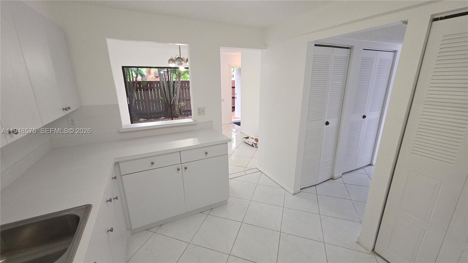 7124 Southwest 114th Place, Unit A Miami, FL 33173 - Photo 6 of 19 a view of a kitchen with white cabinets