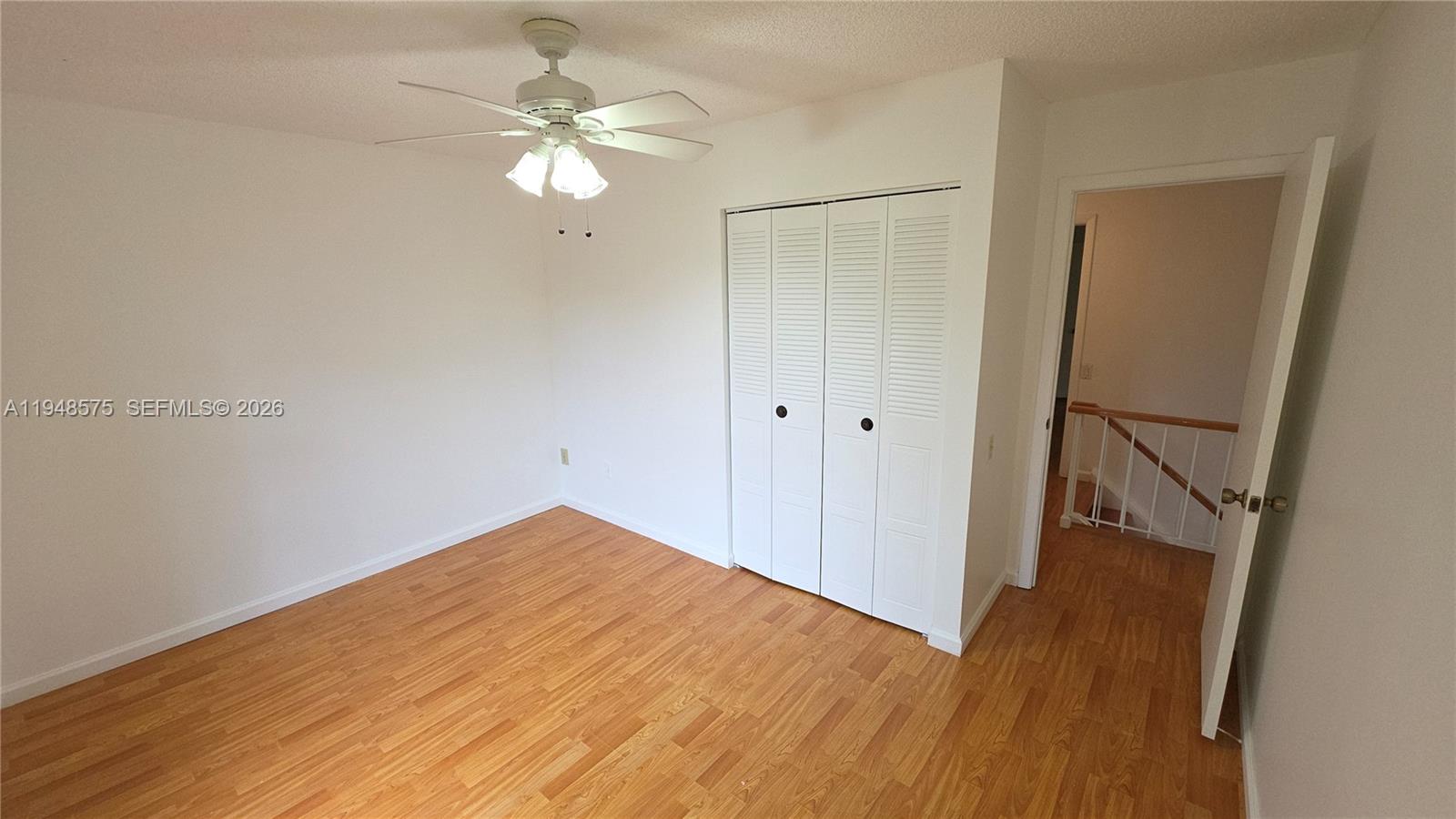 7124 Southwest 114th Place, Unit A Miami, FL 33173 - Photo 9 of 19 a view of an empty room with wooden floor