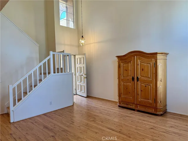a view of a hallway with wooden floor and staircase
