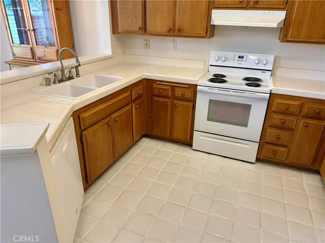 a kitchen with a sink stove and cabinets