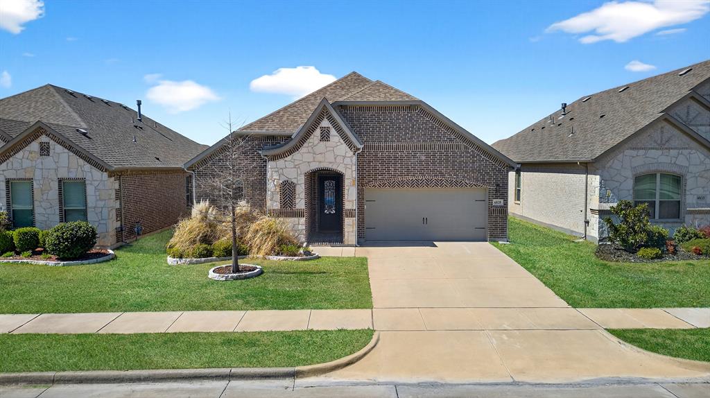 6829 Danridge Road Rowlett, TX 75089 - Photo 27 of 28 a front view of a house with a yard and garage