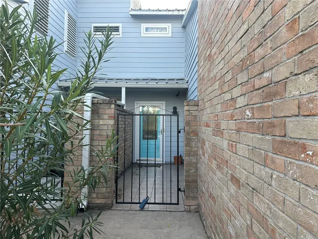 a view of a brick house with a small window