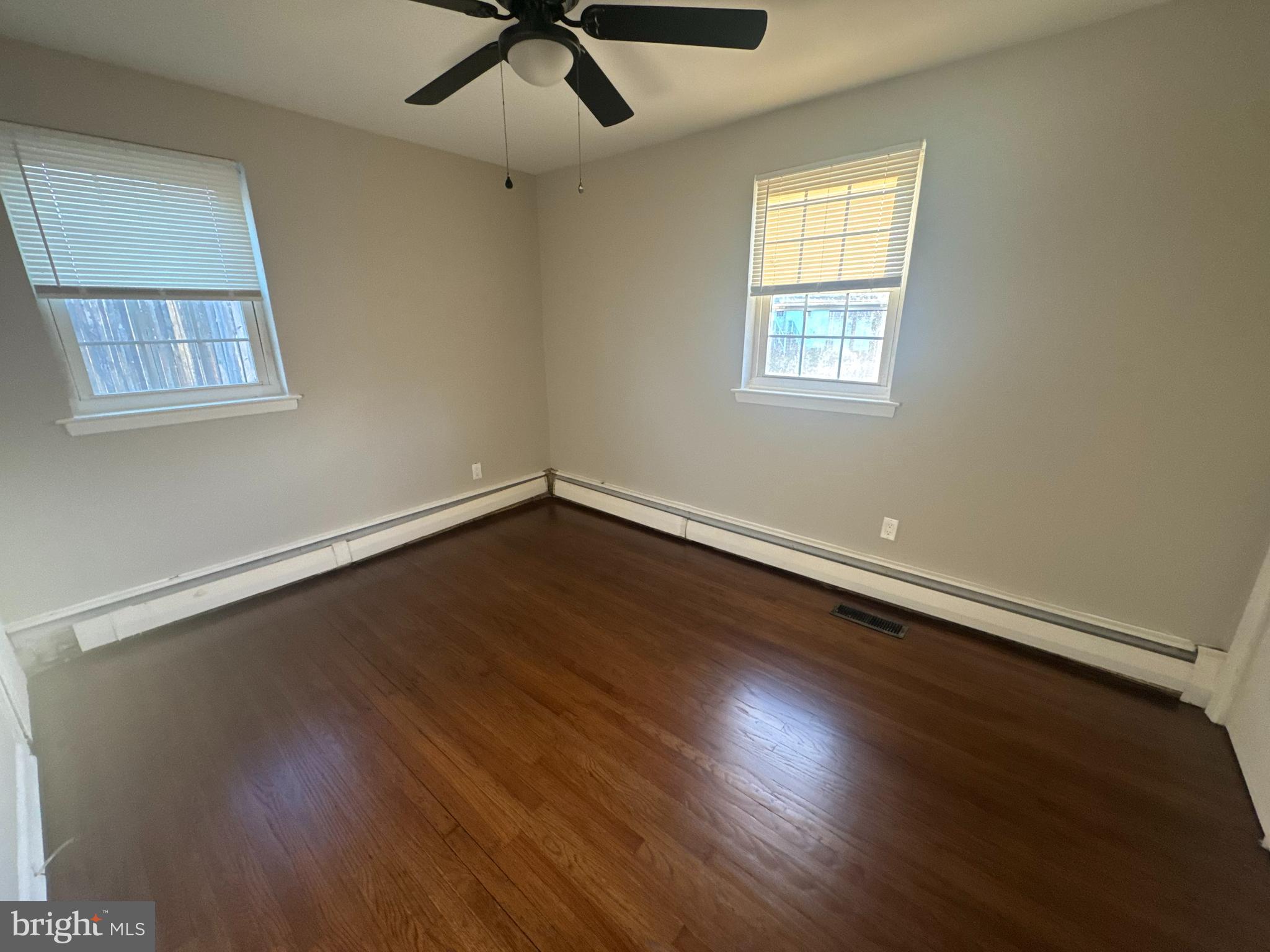 210 Trinity Avenue, Unit A1 Ambler, PA 19002 - Photo 3 of 8 an empty room with wooden floor and windows