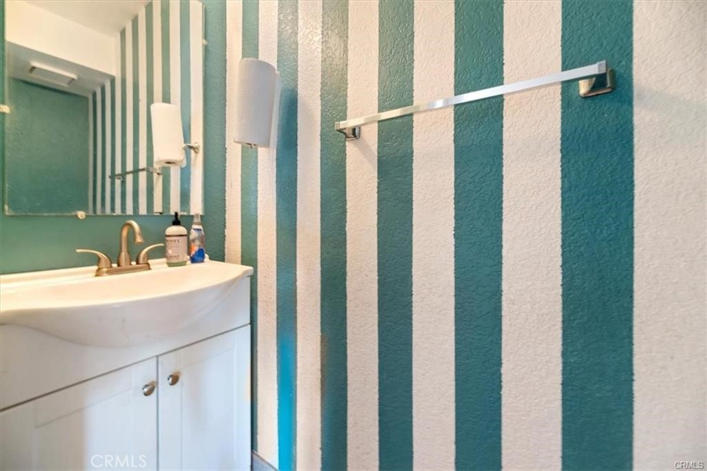 16444 Trelaney Road Fontana, CA 92337 - Photo 15 of 21 a bathroom with a sink and a mirror