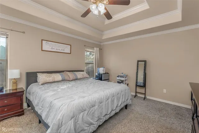 a bedroom with bed and a chandelier