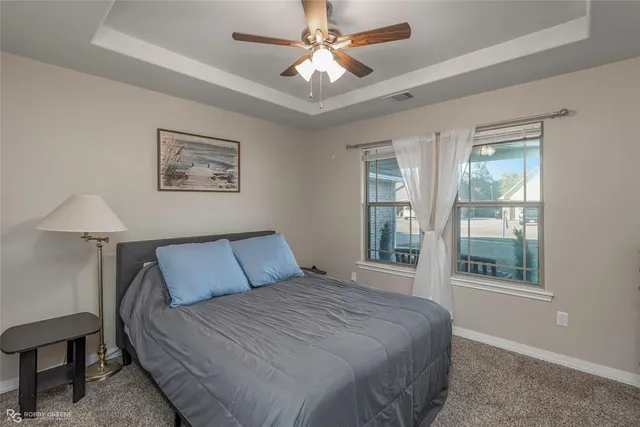 a bedroom with a large bed and a window