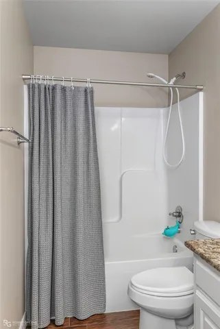 a bathroom with a shower a toilet and a shower